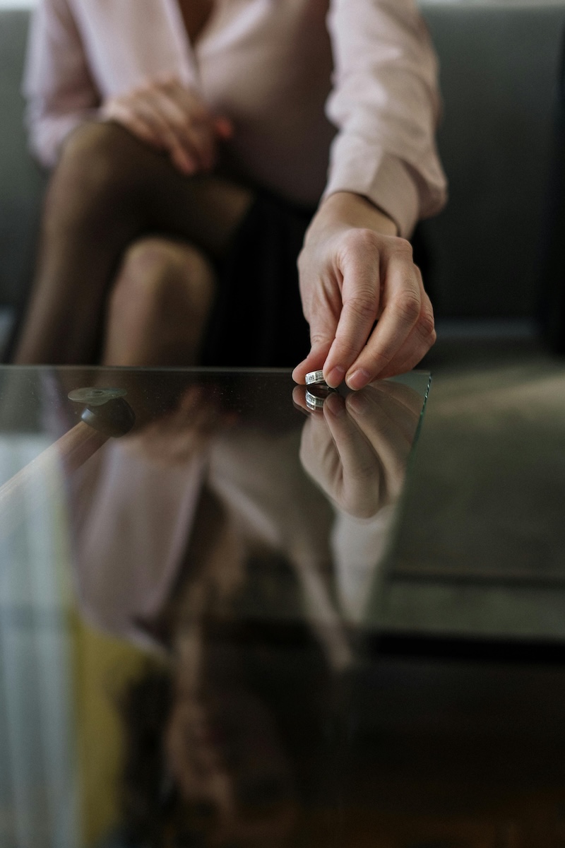 divorce-gw A woman and a man each removing their wedding rings.