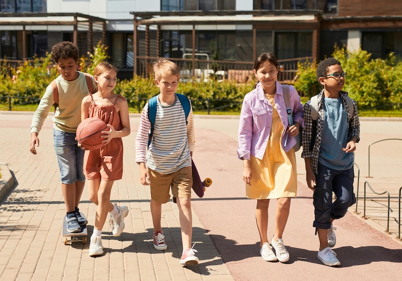 Parenting Decisions A diverse group of kids walk toward school. Courts can decide which parent chooses the child's primary residence and school.
