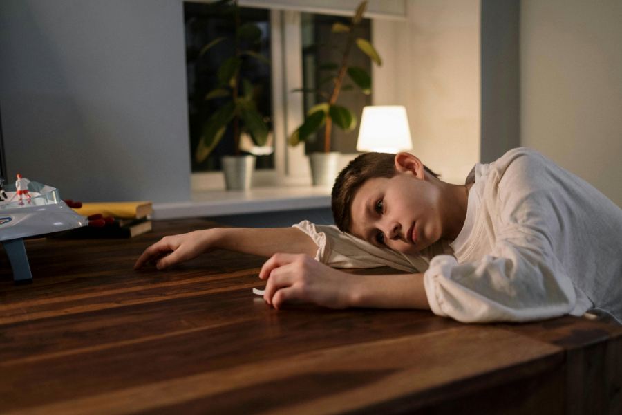 Sad child Greg Whitten - Texas Attorney, at a conference table.